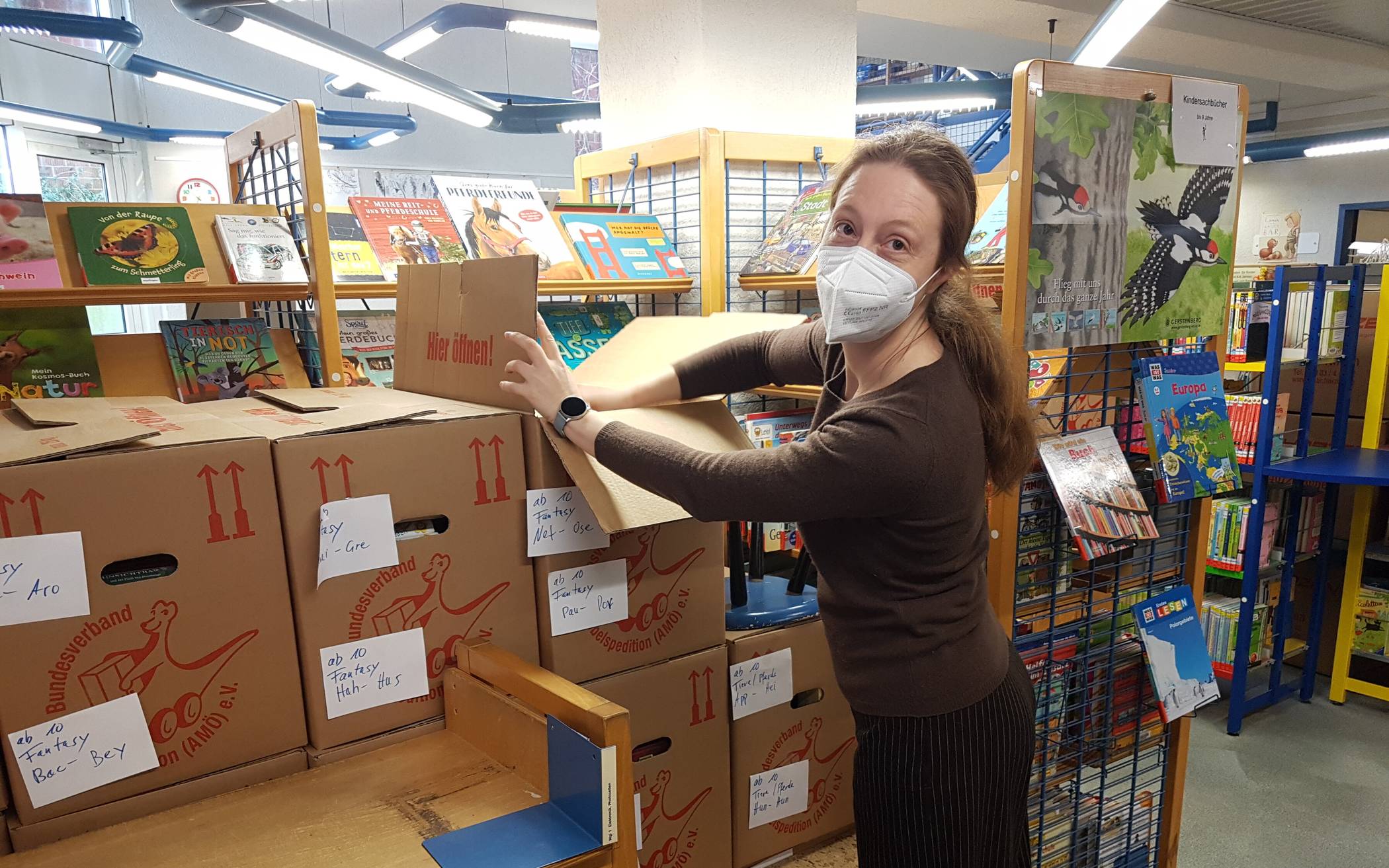 Stadtbücherei-Mitarbeiterin Christin Barthelmie beim Ausräumen der Kartons.  
